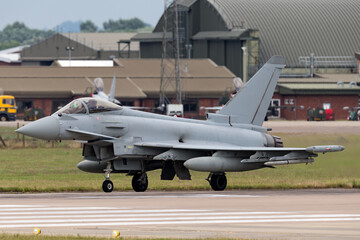 Fighter jet taxiing at a military airbase.