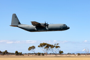 Large military transport aircraft flying at low level.