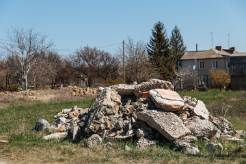 Old construction waste. Reinforcement sticks out of a pile of brick, stone and concrete waste....