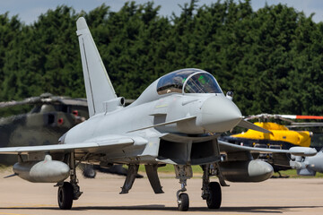 Advanced two seat military jet taxiing at an Air Force base.