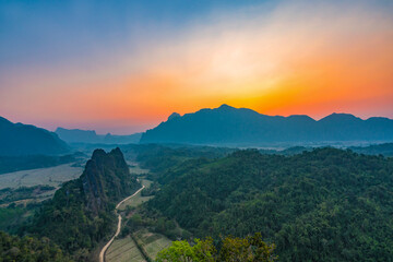 Fototapeta na wymiar Top view of Beautiful Forest landscape of Sunset at pha Namxay Mountains Vang Vieng, Laos