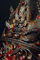 Head of mannequin in decorated hat, dark studio background