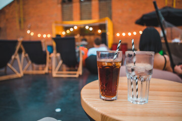 young gorgeous woman sitting in cozy chair at outdoors cafe