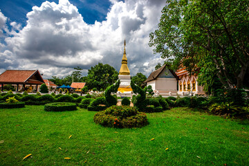 Fototapeta na wymiar Background of an important tourist attraction in Khon Kaen, where tourists come to see the beauty always (Phra That Kham Kaen) is an old pagoda and has a beautiful golden yellow color, in Thailand