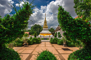 Background of an important tourist attraction in Khon Kaen, where tourists come to see the beauty always (Phra That Kham Kaen) is an old pagoda and has a beautiful golden yellow color, in Thailand