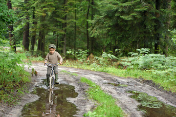 Obraz premium 5 years old boy is having fun. The active child is riding a bicycle. Active recreation.