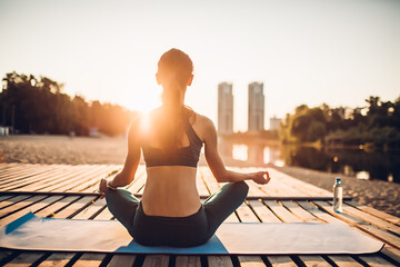 sportswoman meditating at sunrise
