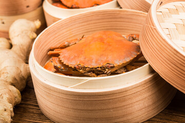 Cooked crab on steamer and Wooden planks background