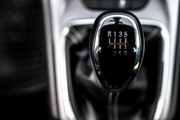 Modern car interior: steering wheel, gearshift lever, multimedia system. Manual transmission driving. Car gearbox lever