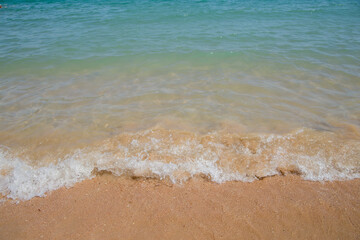 Fototapeta na wymiar clear azure water on the beach with sand