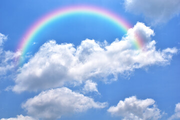 Abstract rainbow on beautiful blue sky and white clouds as background and wallpaper. 
