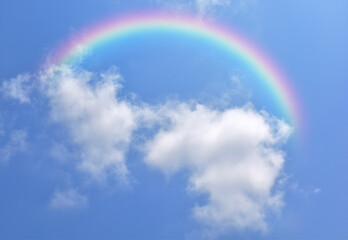 Abstract rainbow on beautiful blue sky and white clouds as background and wallpaper.