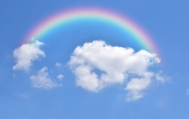 Abstract rainbow on beautiful blue sky and white clouds as background and wallpaper. 