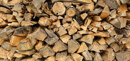 woodpile background. stacked Firewood logs texture. Chipped firewood full frame. template for design. banner