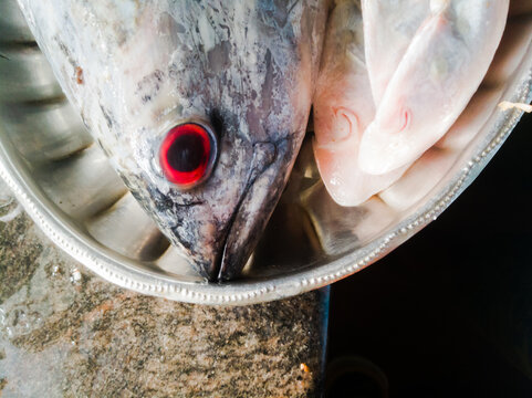 Raw Sea fish with red eyes in a steel plate kerala specials.
