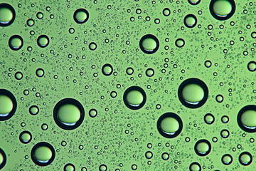 green wet background / raindrops for overlaying on a window, weather, background drops of rain water on a glass transparent