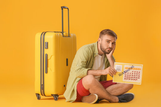Sad man holding calendar with written word QUARANTINE against color background. Vacation concept