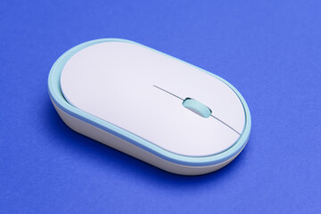 Modern computer mouse on color background