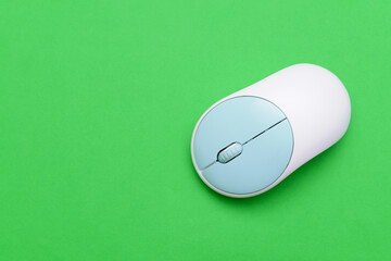 Modern computer mouse on color background