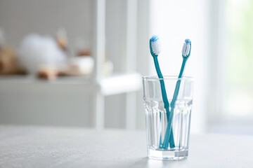 Tooth brushes on table in bathroom