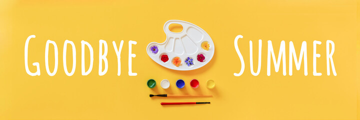 Goodbye Summer and bright colorful flowers on artistic palette, brush and gouache on yellow background with copy space