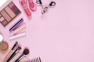 Top view of cosmetics on pink background