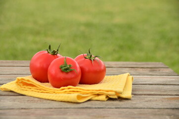 fresh tomatoes on a wooden table