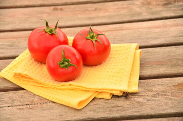 fresh tomatoes on a  wooden table