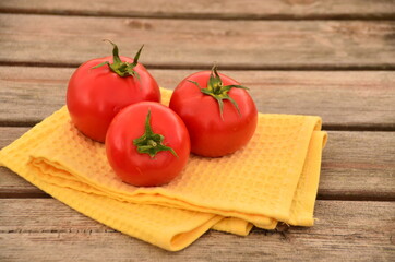 fresh tomatoes on a  wooden table