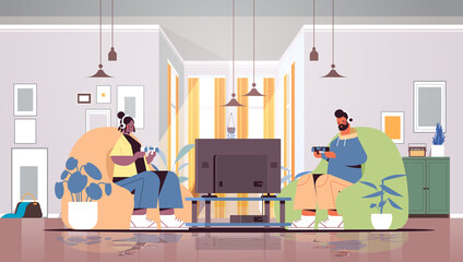 young couple using joysticks playing video games on tv man woman spending time together at home living room interior horizontal full length vector illustration
