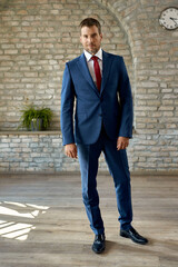 Full length of confident businessman in the office.