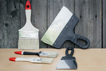 Tool for painting work. Spatula and brushes. Set of items for repair. Top view of a builder with a...