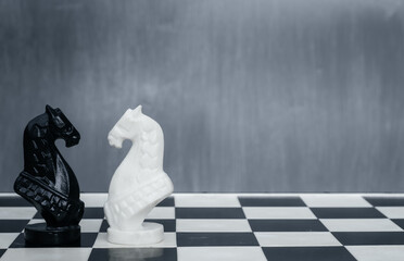 Black and white chess pieces on the chessboard. The concept of combating racism. Motivational...