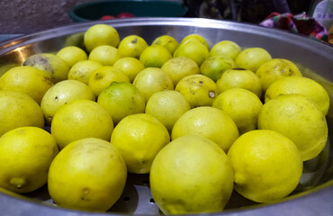 fresh yellow lemons in a bowl, close-up