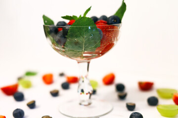 berry cocktail in a crystal glass with strawberries, blueberries, blueberries and mint close up