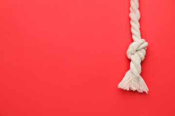 Rope with knot on color background