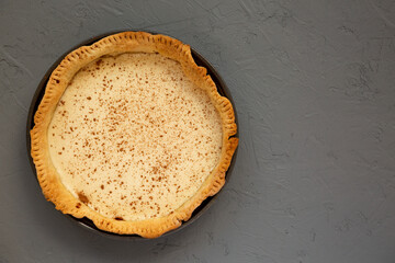 Homemade Sugar Cream Pie on a gray surface, overhead view. Flat lay, top view, from above. Copy space.