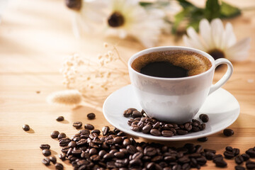 Coffee and flower with the morning sunlight