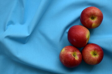 Red Apples on light blue background.