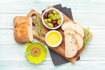 Ripe olives, olive oil and ciabatta bread