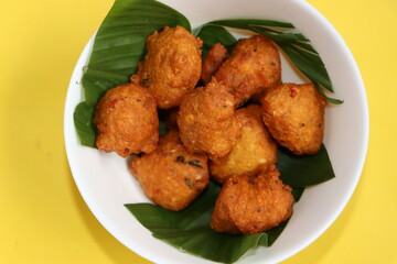 Moong Dal Pakora, green gram fritters, served on turmeric leaves, Indian food