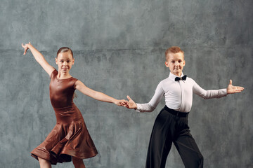 Young couple boy and girl dancing in ballroom dance Samba.