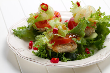 Low-calorie turkey and onion burger with lettuce, tomatoes and cucumbers