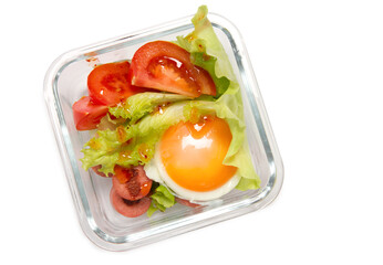 Children's lunch box: fried eggs, sausages, tomatoes and lettuce