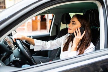 Driver woman driving a car distracted talk on the phone