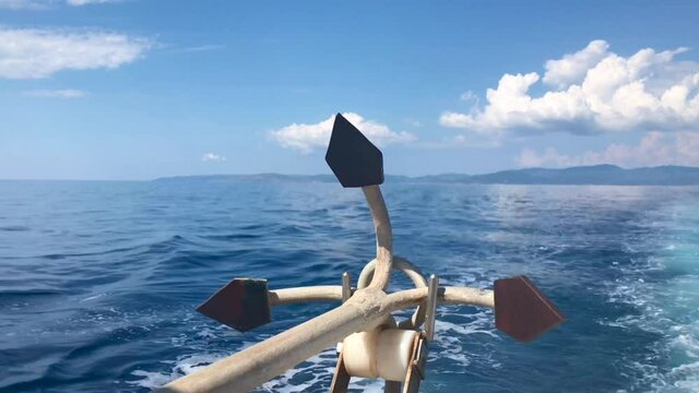 Closeup of large iron drop anchor at the back of sailing ship in 4k in Sithonia on Mediterranean sea