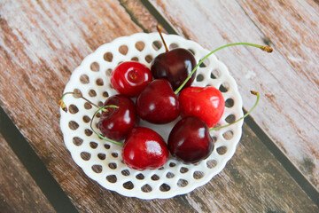 natural red cherry fruits in a decorative plate