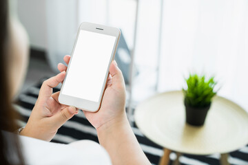 Woman hand holding smartphone and touching blank screen. Mockup of advertisement.