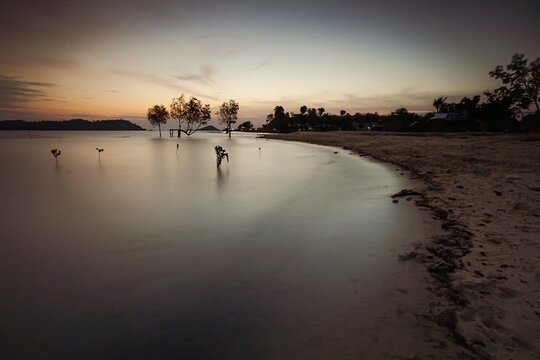 STOKOK BEACH, BATAM/IND. - AUGUST 1, 2020: An HDR photo made from several individual exposures at twilight, of Stook Beach's Barelang beach, harbor and basin area.
