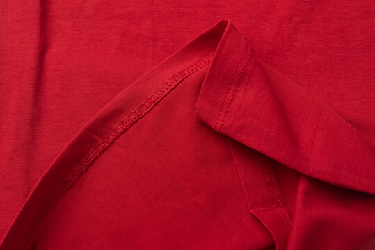 Red cotton fabric close up. hem tee shirts, dress hem. fabric stitching